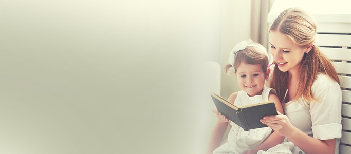 mother reading a book to her daughter