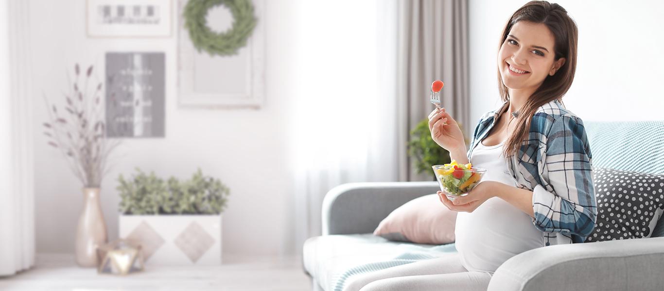 Pregnant woman eating fruits
