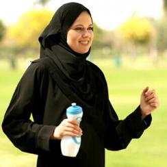 Woman walking and holding a bottle of water