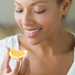 Woman eating orange