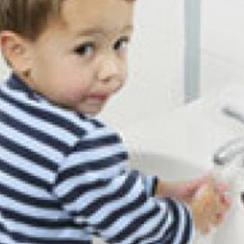 Boy washing his hands